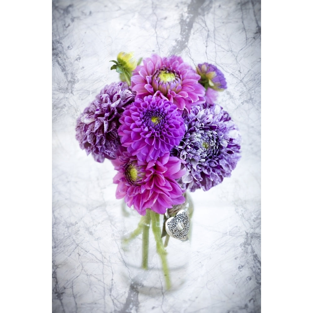 Purple marbled dahlias arranged in a glass jar on a marble counter by Lorna Rande / Design Pics Image 1