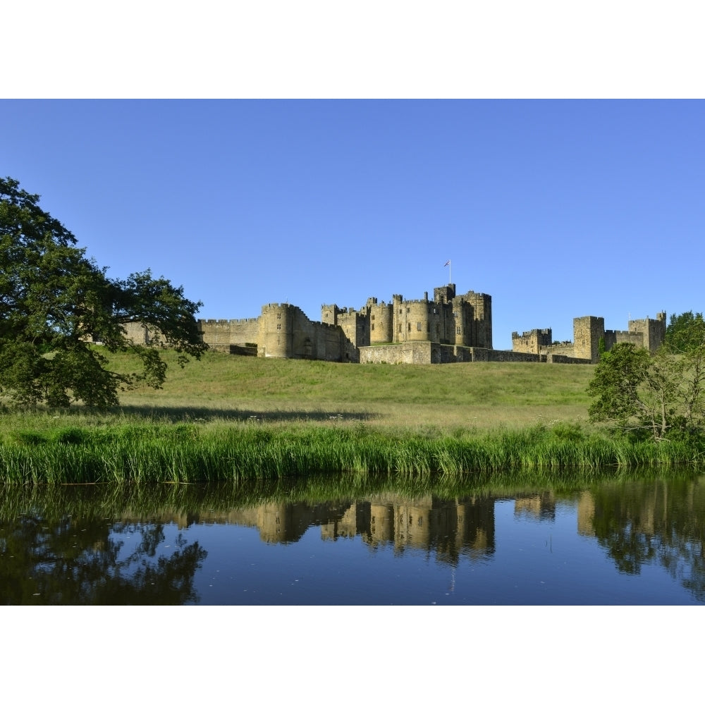 Alnwick Castle reflected on the River Aln; Alnwick Northumberland England by Margaret Whittaker / Design Pics Image 1