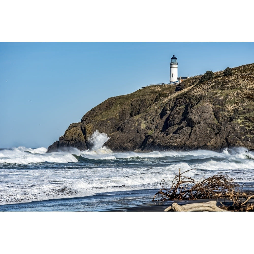 Waves crash on the rocks below the Cape Disappointment North Head Lighthouse near Ilwaco; Washington United States of Image 1