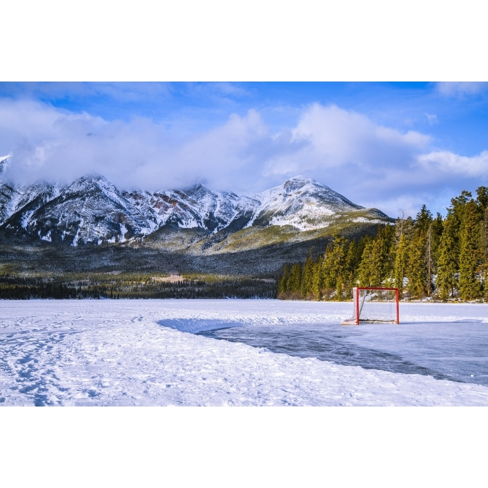 Frozen Pyramid Lake with hockey net on a cleared ice rink in winter Jasper National Park; Alberta Canada Poster Print by Image 1