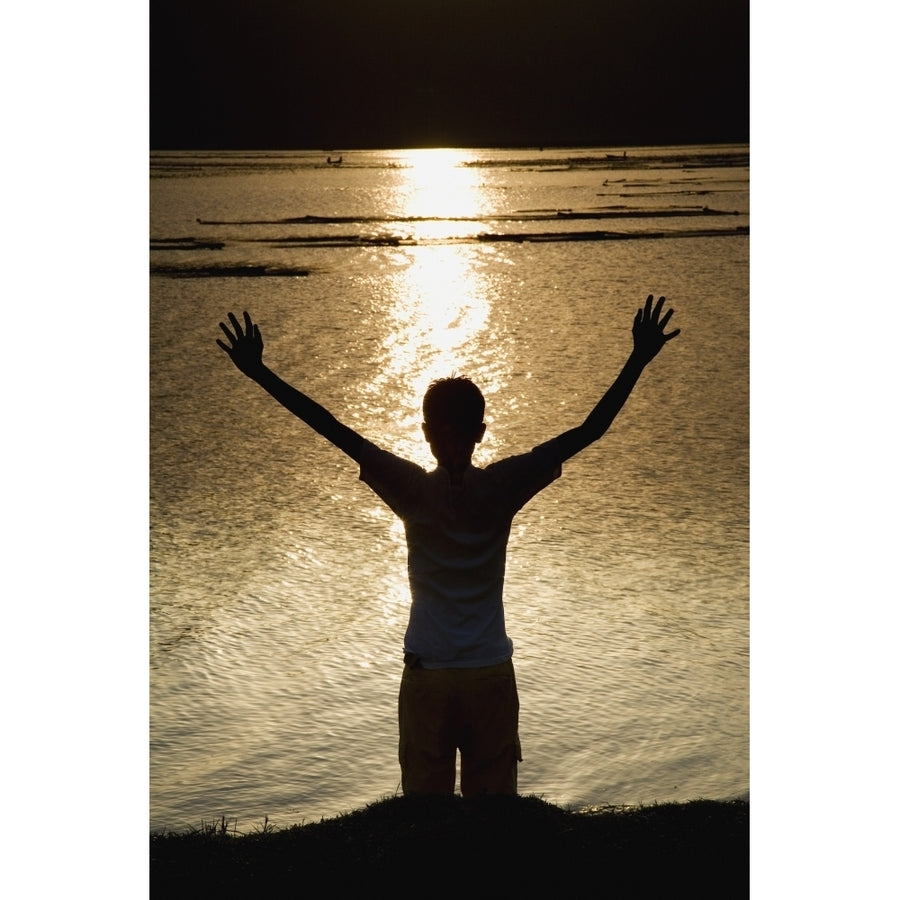 Child Stretching Arms To The Sky At River Bank Poster Print by Sean White / Design Pics Image 1