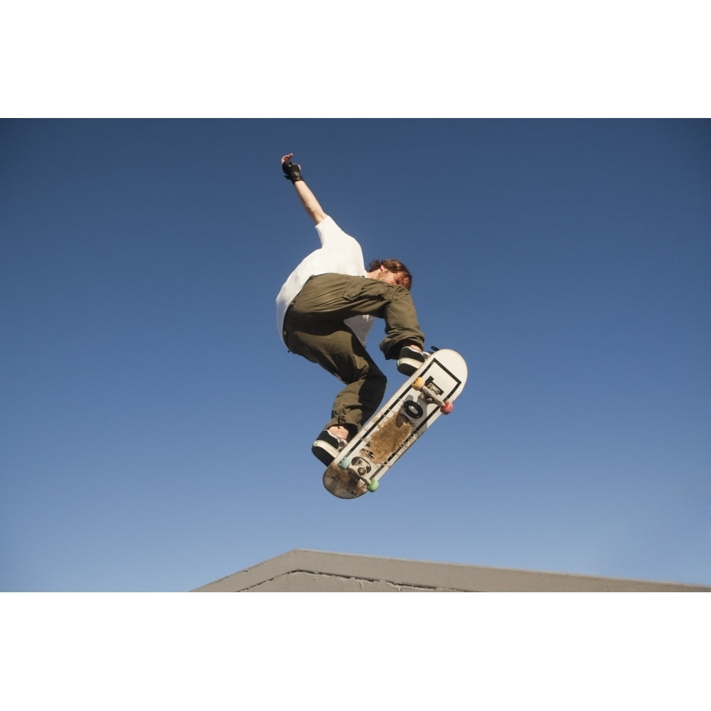 Low Angle View Of Young Male Skateboarder Poster Print Image 1