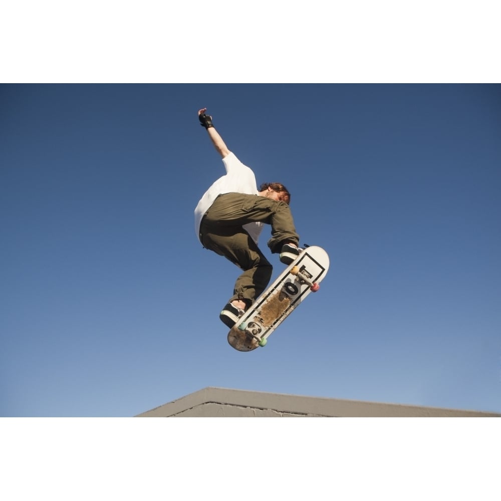 Low Angle View Of Young Male Skateboarder Poster Print Image 1