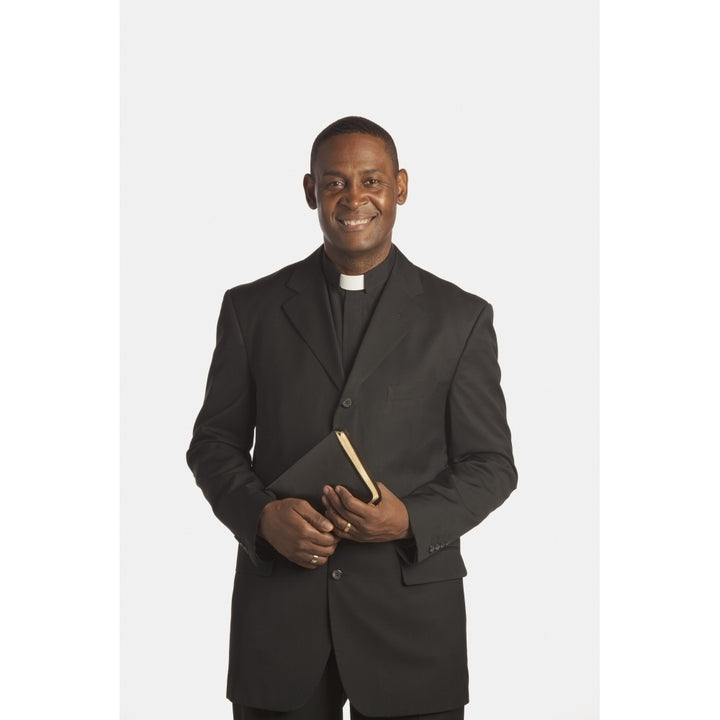 A Man Wearing A Clerical Collar And Holding A Bible Poster Print by Ron Nickel / Design Pics Image 1