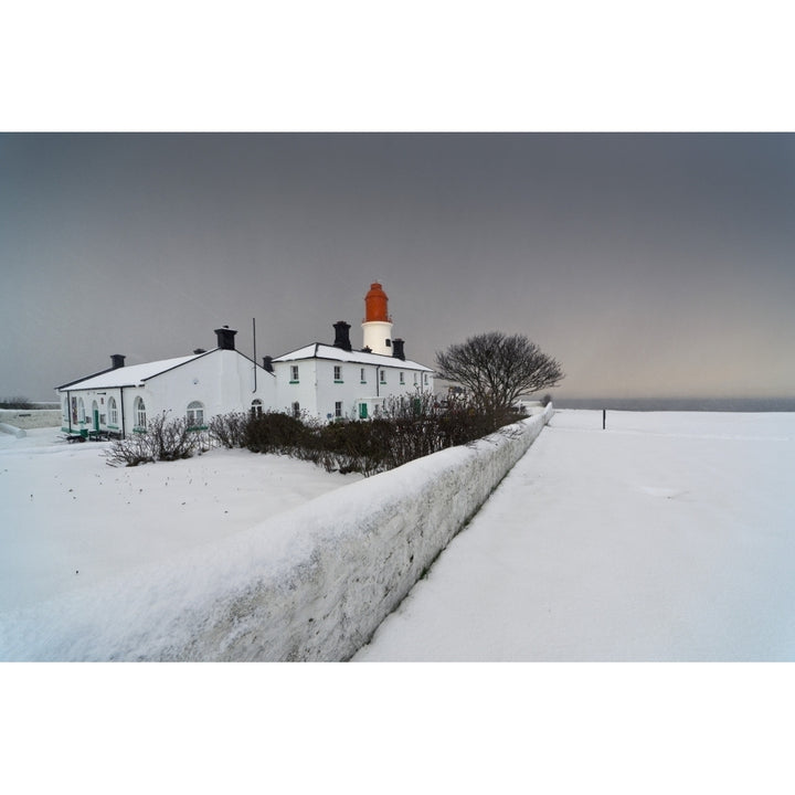 A Snow Covered Fence With A Lighthouse And Building In The Background; South Shields Tyne And Wear England Image 1