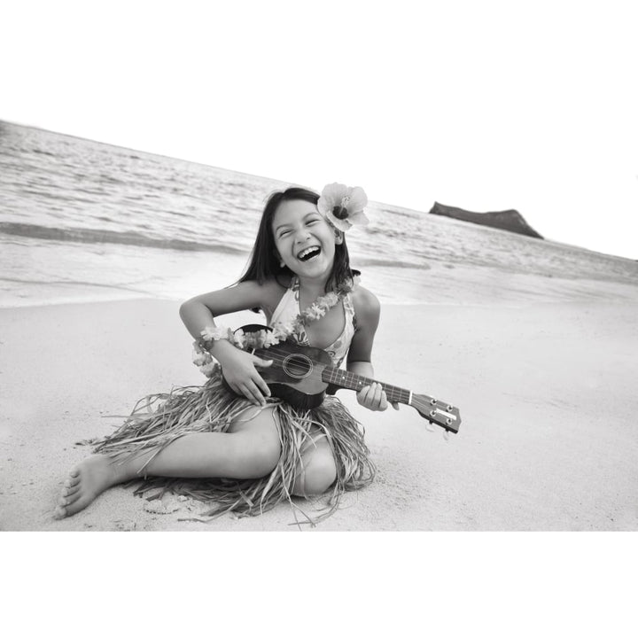 Hawaii Oahu Young Girl Smiling And Playing Ukulele On The Beach In A Hula Skirt. Poster Print Image 1