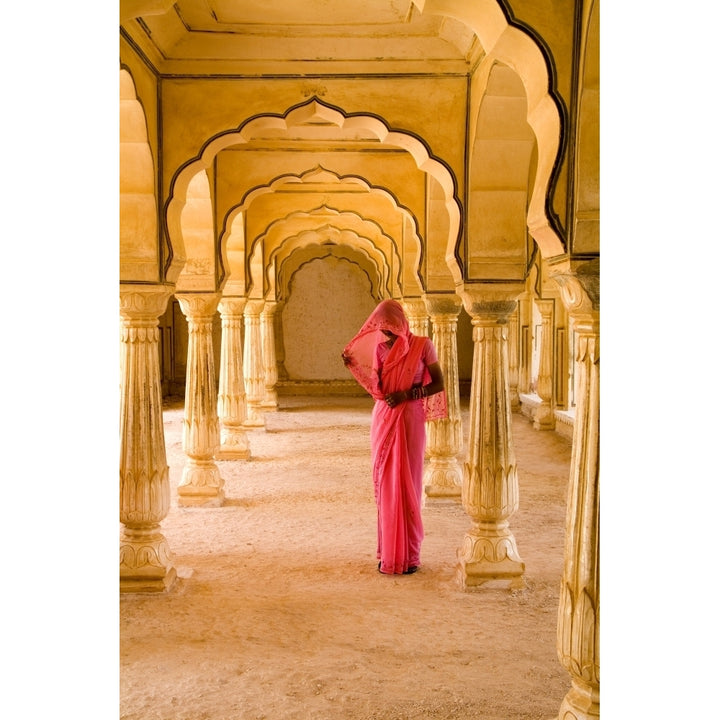 India Rajasthan Jaipur Amber Fort Temple Woman In Bright Pink Sari Stands Beneath Arches. Poster Print Image 2