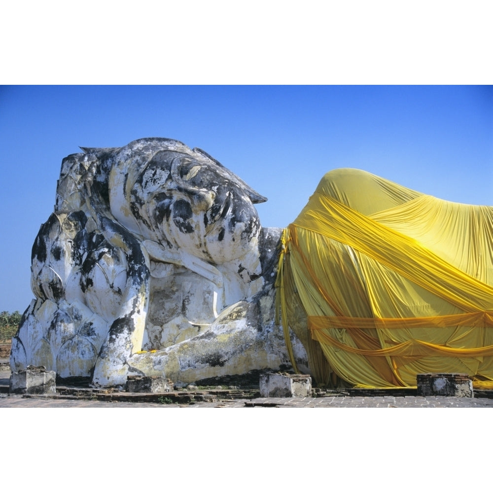 Reclining Budda statue wrapped with yellow cloth Poster Print Image 1