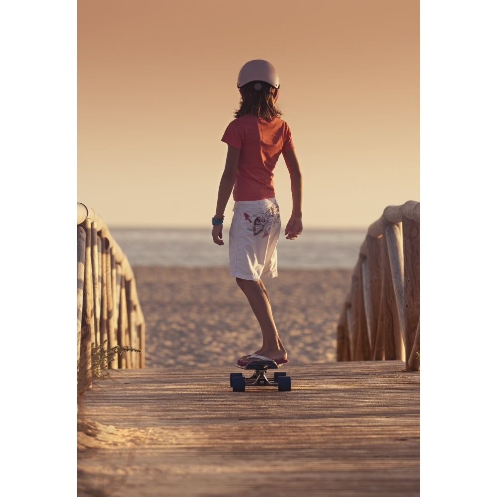 A Young Person Skateboarding With Bare Feet Over A Wooden Boardwalk Towards The Image 1