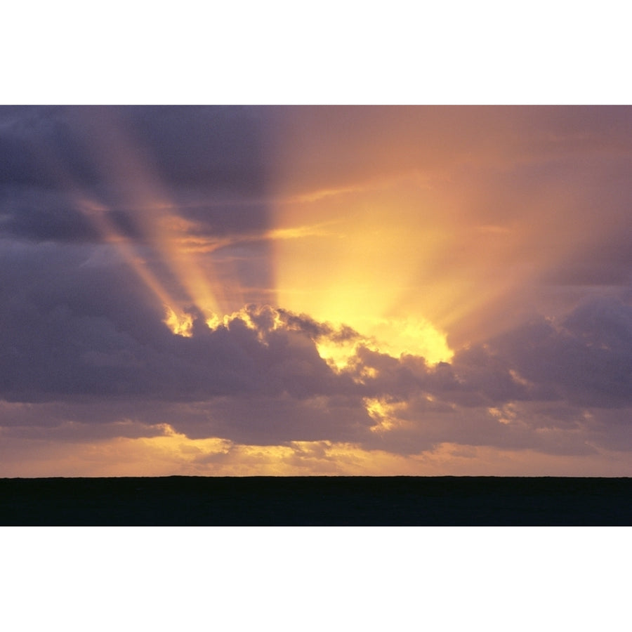 Sunrays Stream Out From Behind Clouds At Sunset Over Dark Ocean Poster Print Image 1