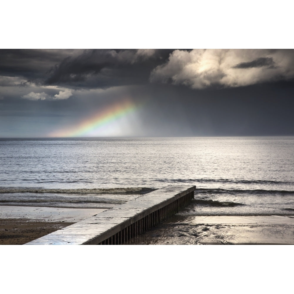 A rainbow shining in the storm clouds;Blyth northumberland england Poster Print Image 1