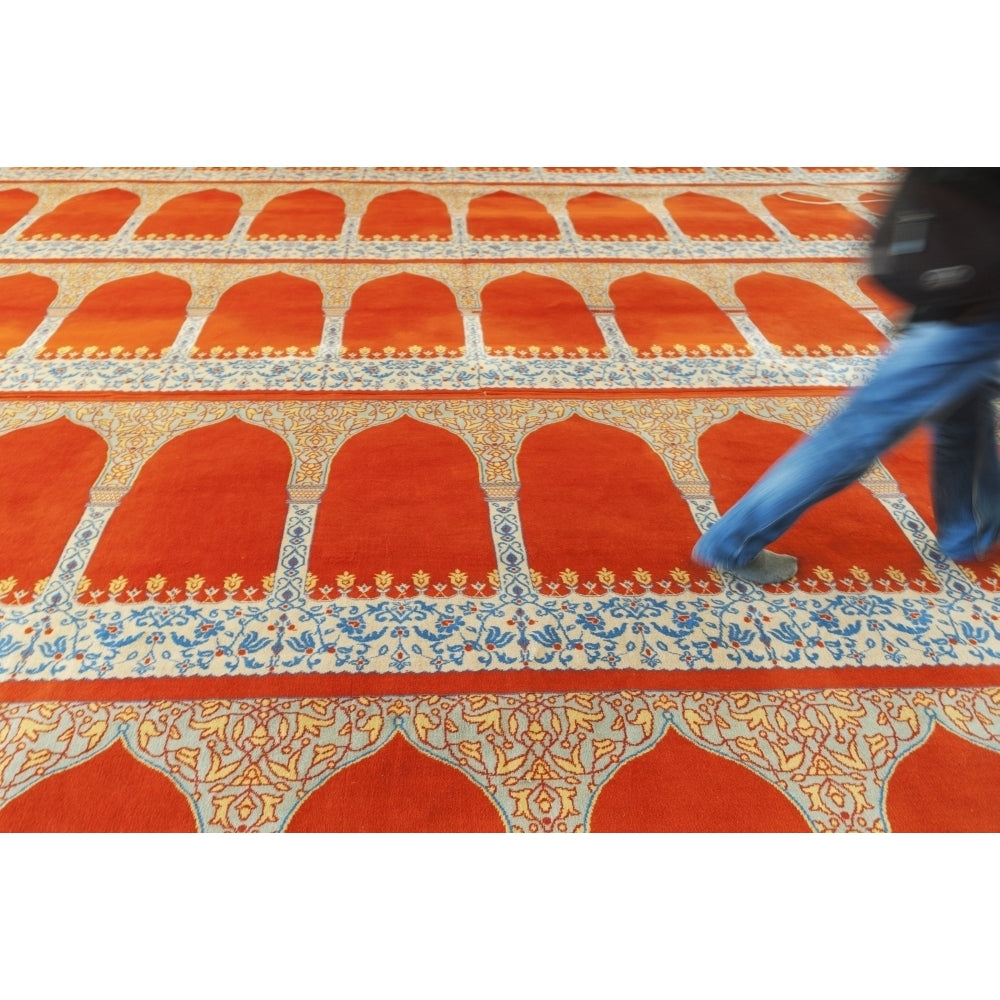 A person walking over the colourful carpet in the suleymaniye mosque;Istanbul turkey Poster Print Image 1