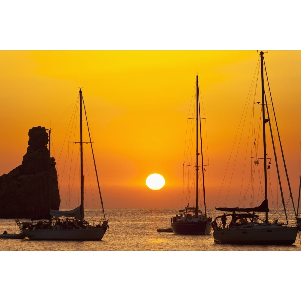 Spain Yachts and strange shaped rock off Benirras beach at dusk; Ibiza Poster Print Image 2