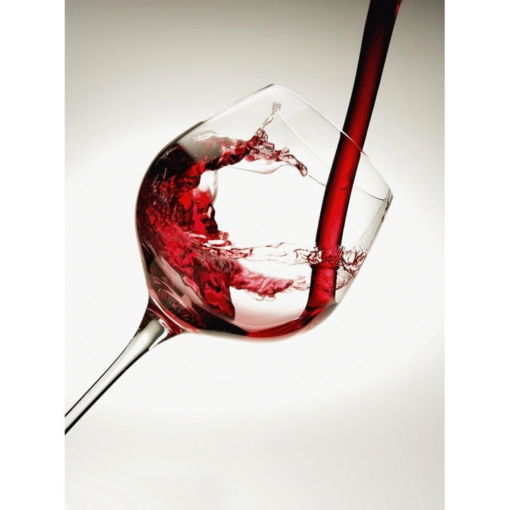 Red wine pouring into a glass Poster Print Image 1