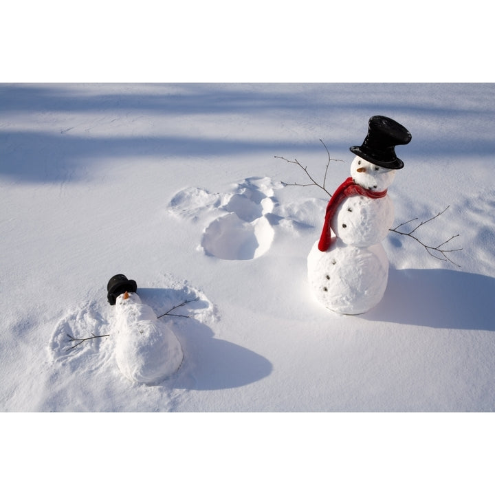 Snowmen In Forest Making Snow Angel Imprint In Snow In Late Afternoon Sunlight Alaska Winter Poster Print Image 1