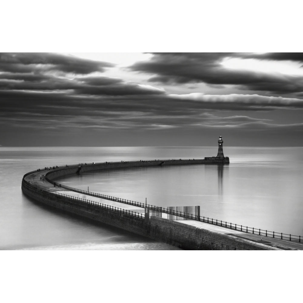 A curving pier with a lighthouse at the end;Sunderland tyne and wear england Poster Print Image 1