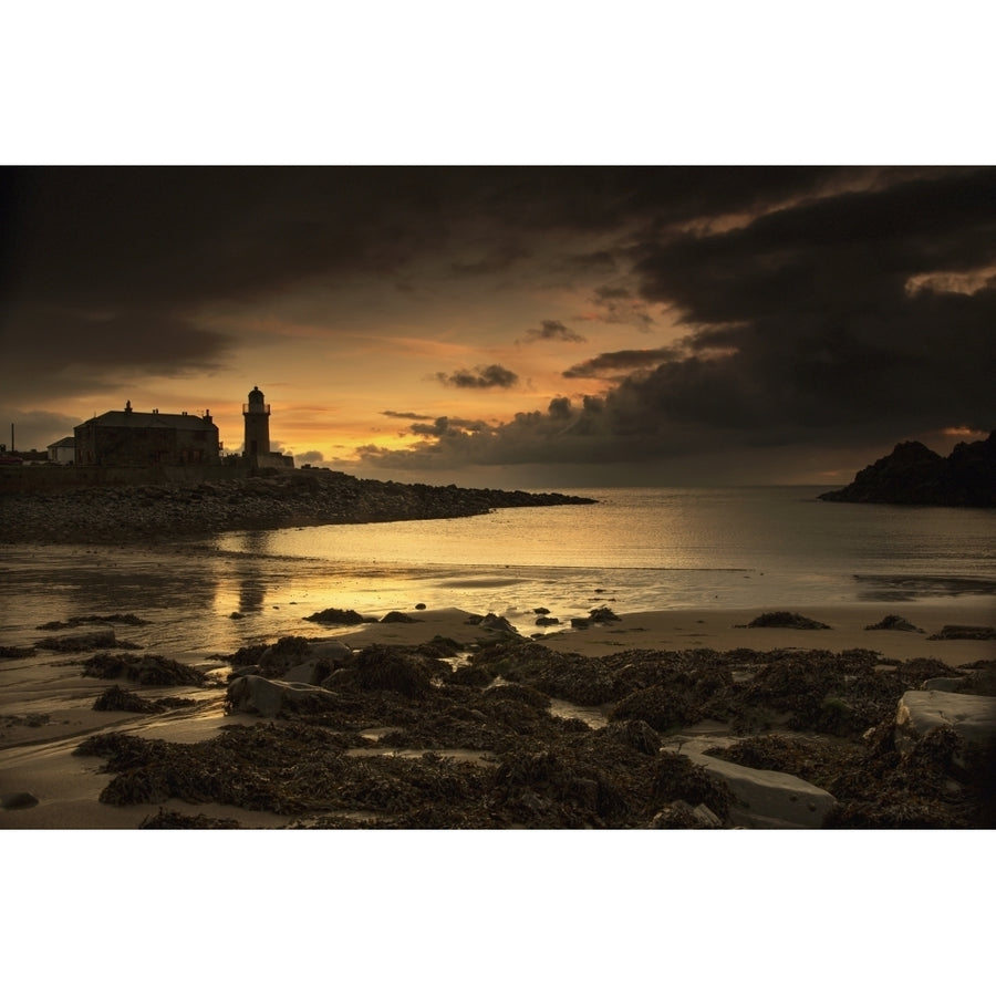 Silhouette of a lighthouse along the coast at sunset;Portpatrick dumfries and galloway scotland Poster Print Image 1