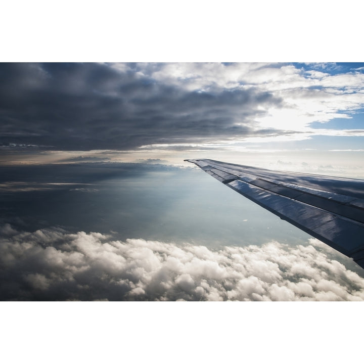 A commercial jet flies through the clouds; Colorado United States of America Poster Print by Robert L. Potts / Design P Image 1