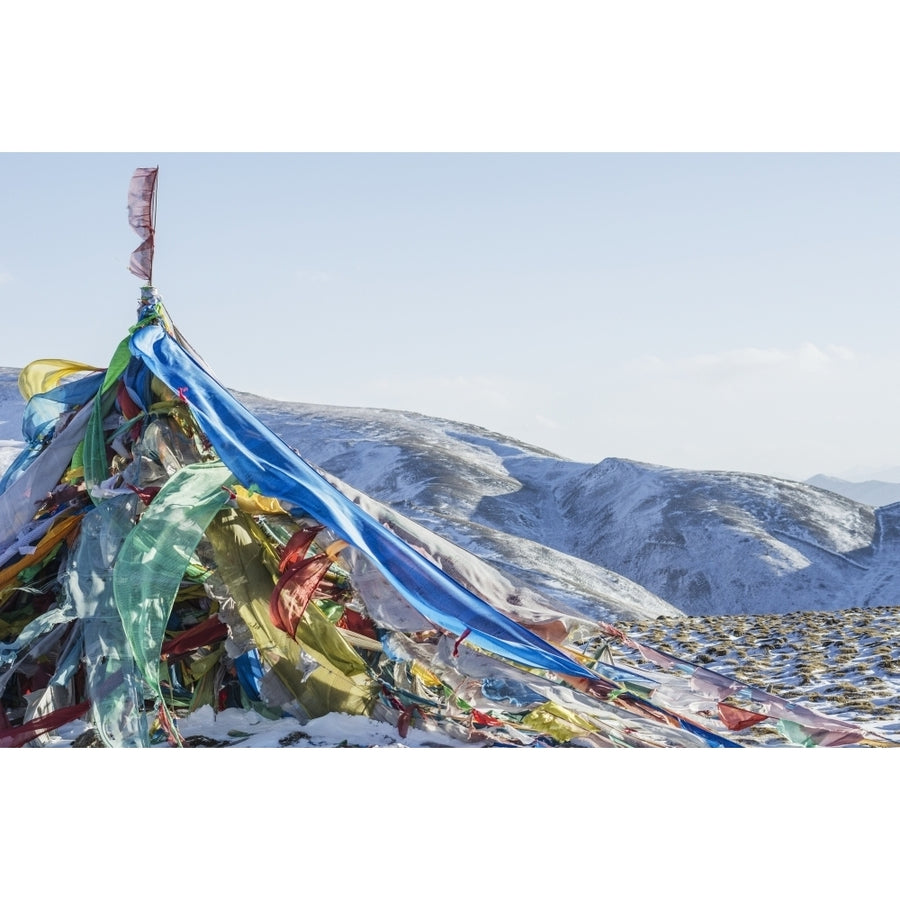 Snowy landscape with prayer flags on a high altitude mountain pass; Tibet Poster Print Image 1