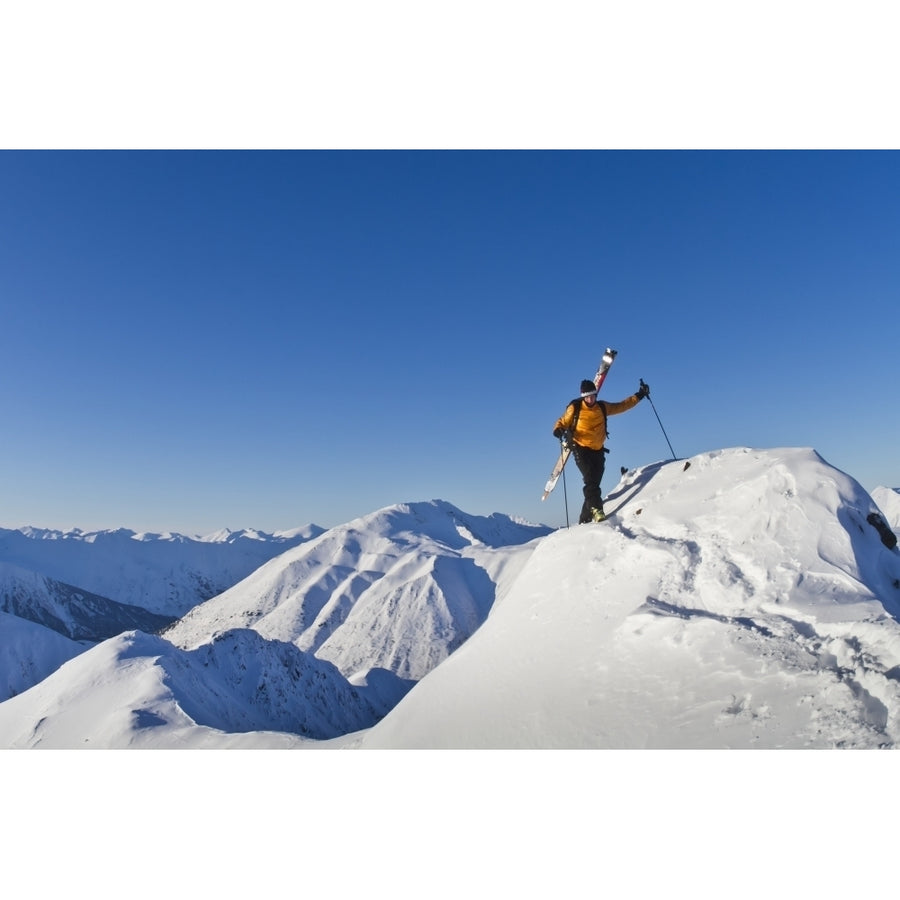 Man climbing a snow ridge for back country skiing Turnagain Pass Kenai Mountains Southcentral Alaska Winter Poster P Image 1