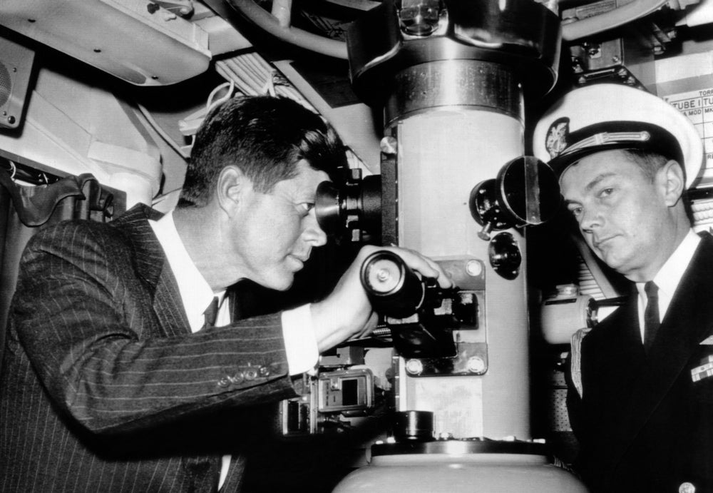 President John Kennedy Looks Through The Periscope Of The Nuclear Submarine Uss Thomas A. Edison. At Right Is His Naval Image 1