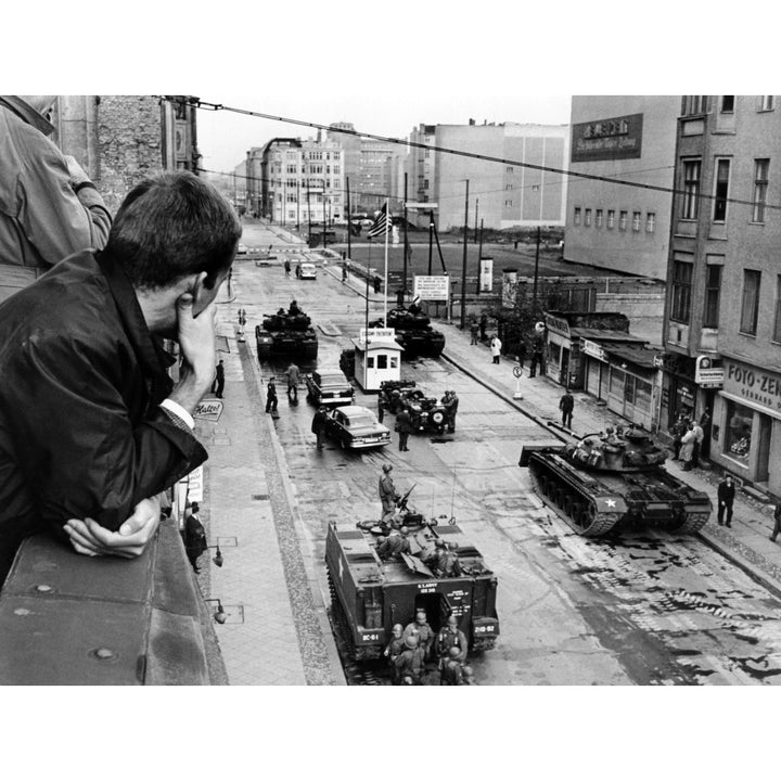 American Tanks At The Friedrichstrasse Checkpoint Crossing Through The Berlin Wall. A Man Looks Down From A Window At Image 1