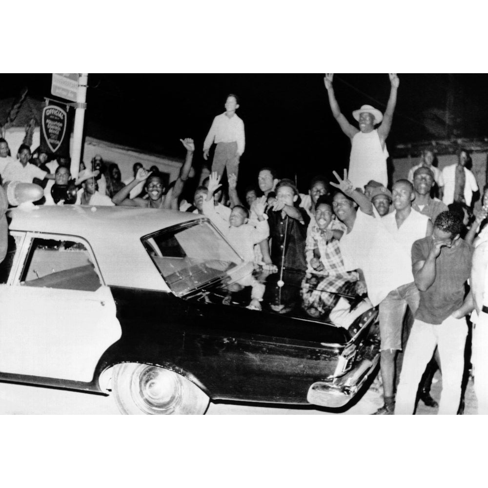 African American Jeer Police During The 1965 Watts Riots. Young Men Stand On A Police Car On The Second Night Of The Image 1