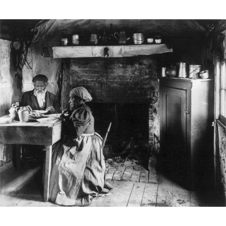 Elderly African American Couple Eating At The Table By A Fireplace History Image 1