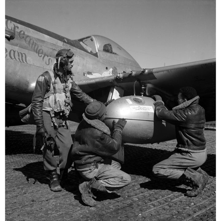 A Tuskegee Fighter Pilot And Two Airmen Adjusting An External Seventy-Five Gallon Drop Tank On The Wing Of A P-51D Image 1