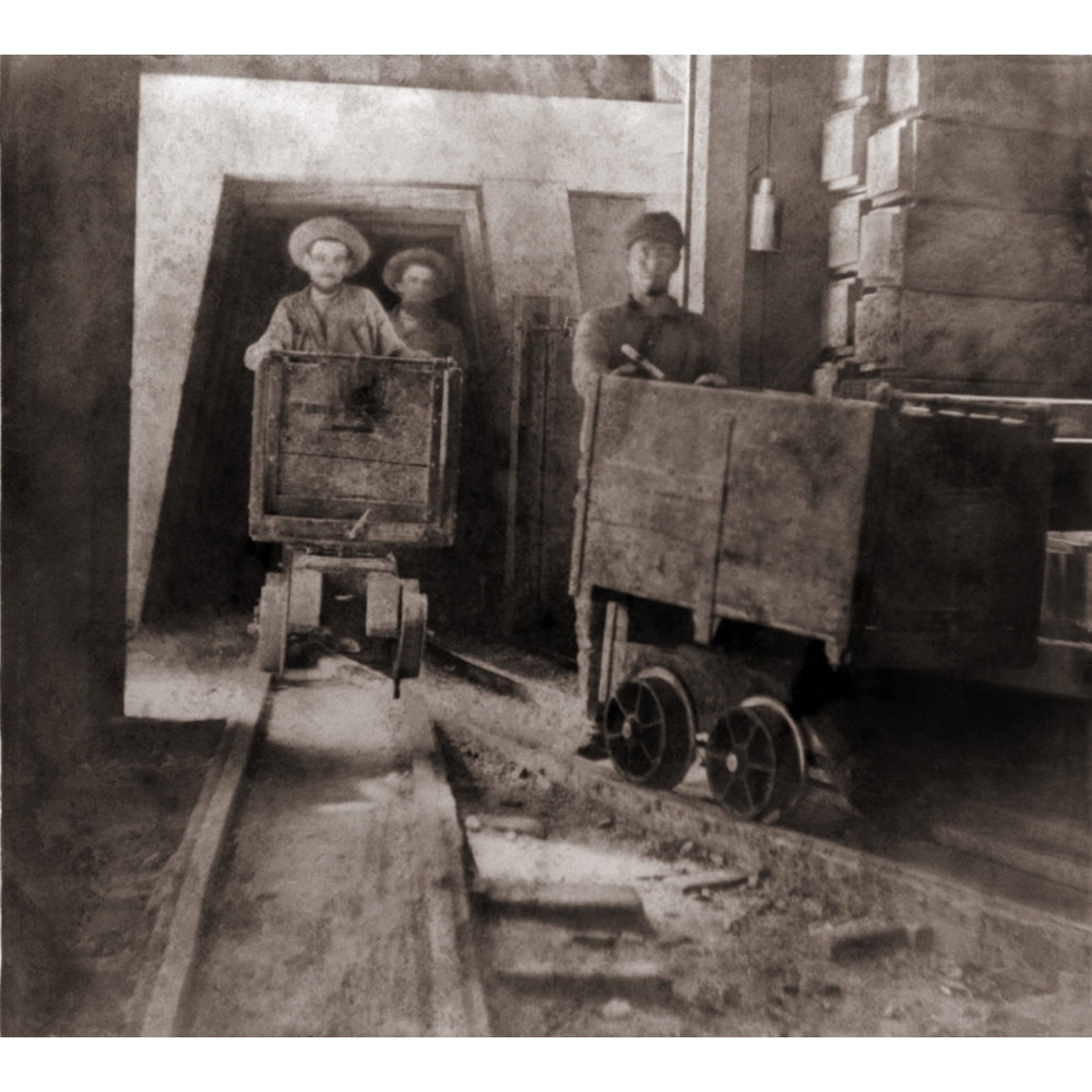 Miners Pushing Ore Carts Through The Tunnels Of The Gould and Curry Mine In Virginia City History Image 1