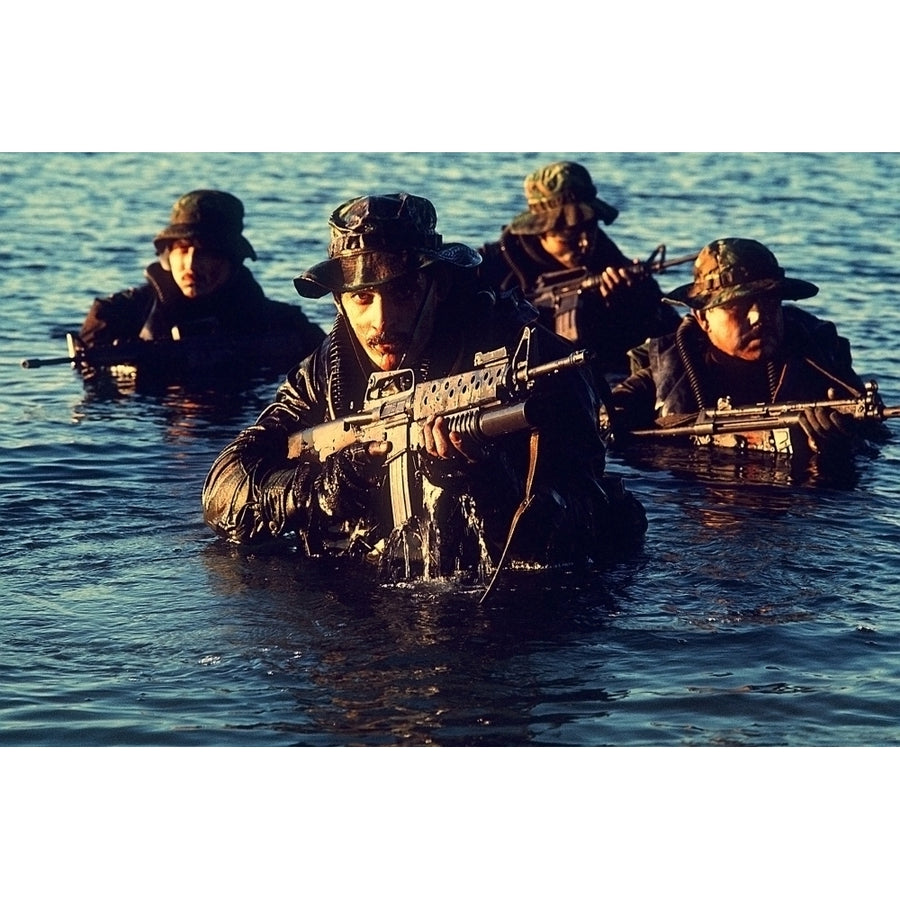 Us Navy Seal Team Emerges From Water During Warfare Training. Foreground Seal Is Armed With An M-16 Rifle Equipped With Image 1