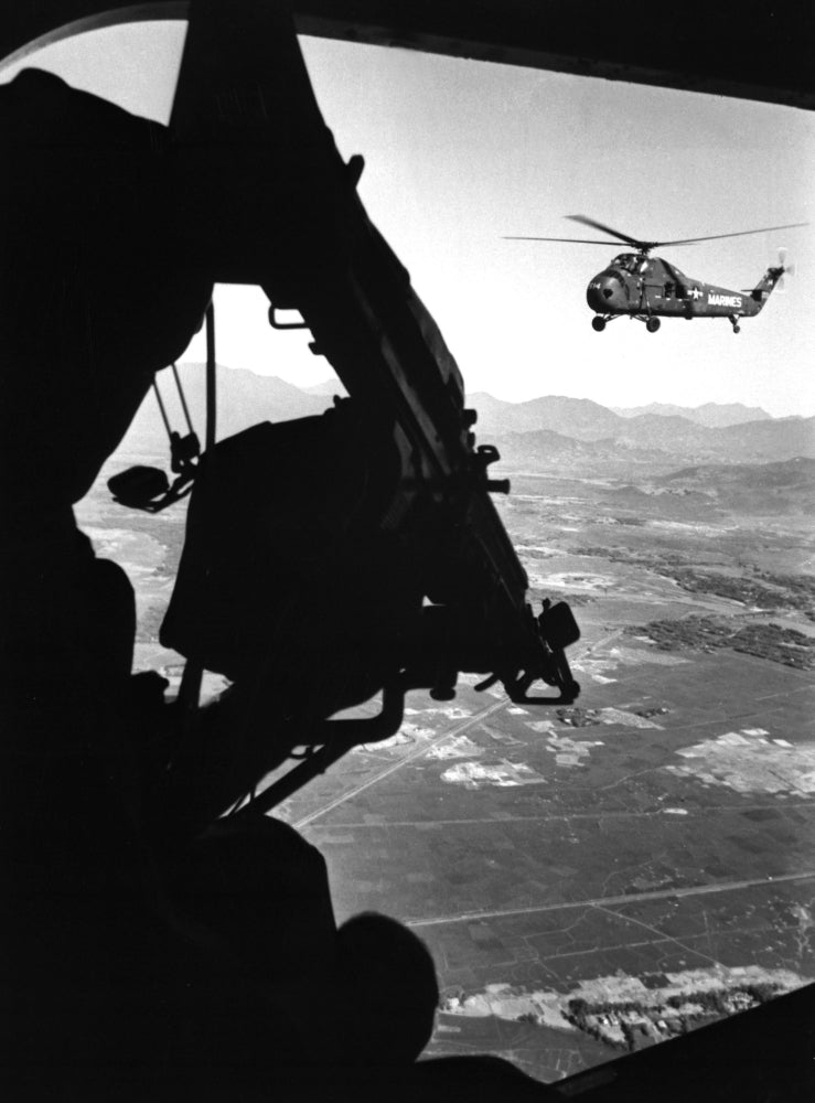 Vietnam War. Us Army Helicopter In Flight Viewed From Behind The Door Gunner Of A Companion Helicopter. Ca. 1965. Image 1