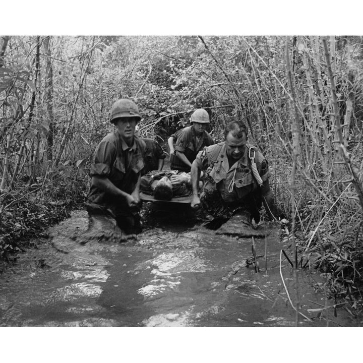 Vietnam War. Us Soldiers Carry A Wounded Comrade Through A Swampy Area. 1969. History Image 2