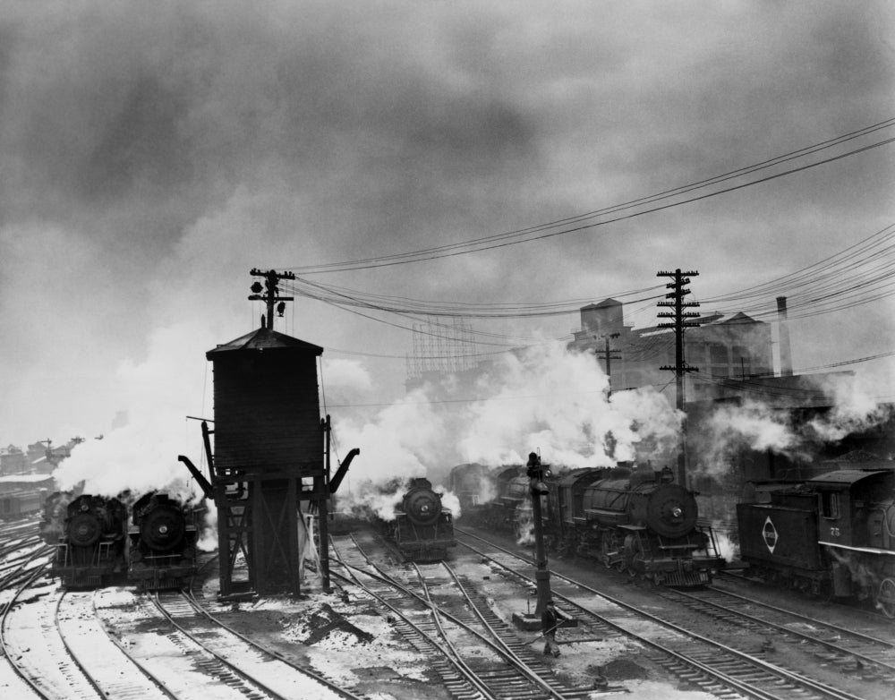 Locomotives And A Water Tower At The Erie Railroad Yards History Image 1