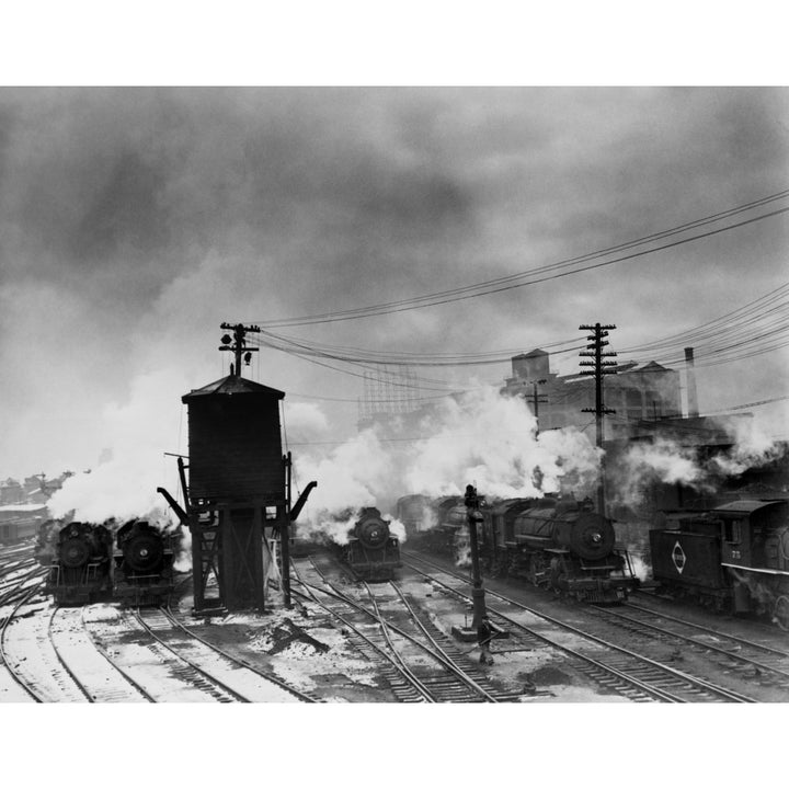 Locomotives And A Water Tower At The Erie Railroad Yards History Image 2