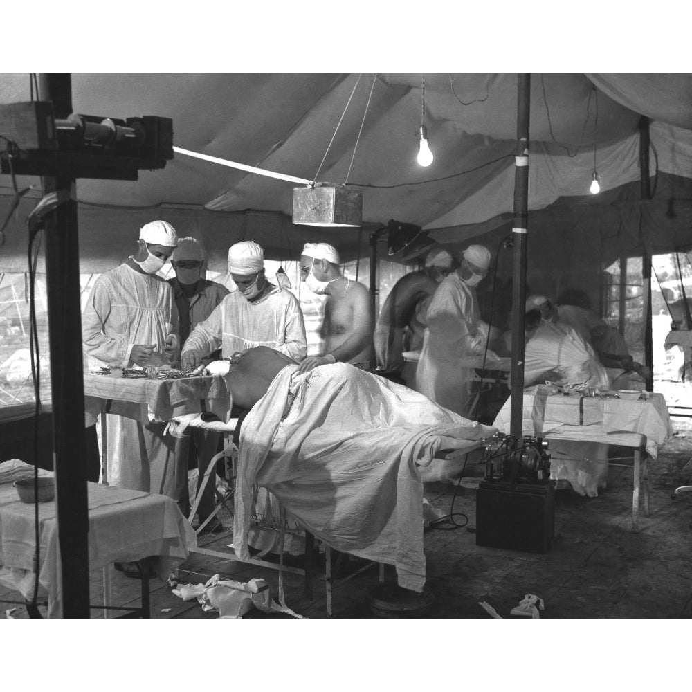 U.S. Navy Doctors And Corpsmen Operate On Two Wounded Marines On Cape Gloucester. The Tented Operating Room Was Set Up Image 1