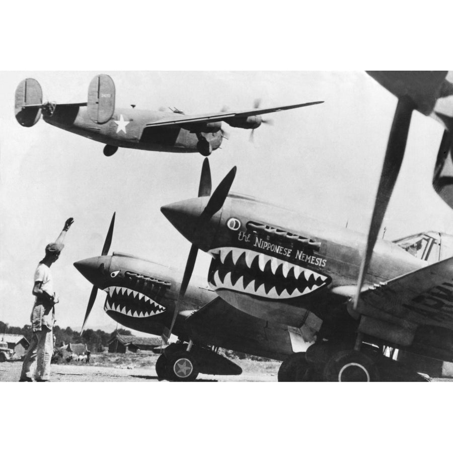 An American B-24 Liberator Bomber Takes Off From An Advanced U.S. Base In China. On The Ground Are Shark Nosed P-40 Image 1