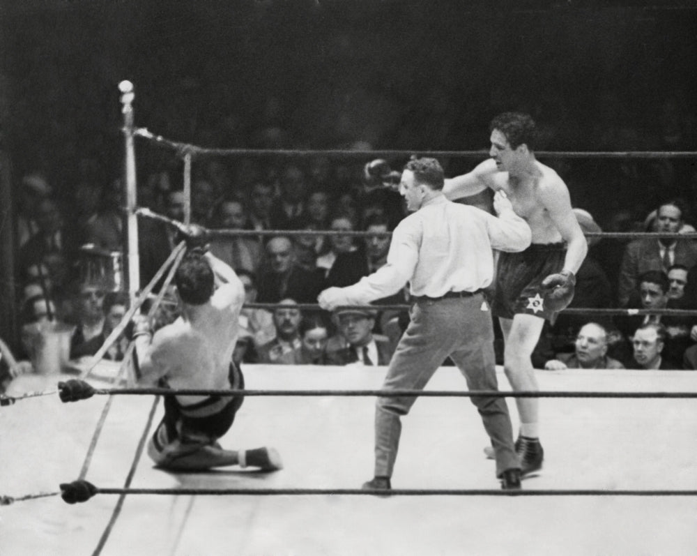 Primo Carnera Lost His Heavyweight Championship To Max Baer. Photo Shows Carnera On The Ropes In The Tenth As Referee Image 1