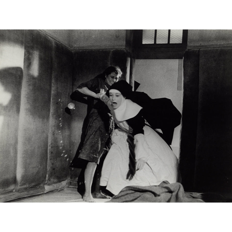 Film still of Audrey Hepburn dressed as a nun being thrown into a cell Photo Print Image 1