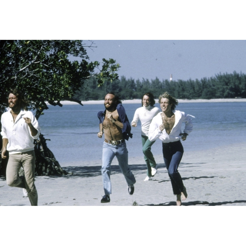 the Bee Gees running at a beach Photo Print Image 1