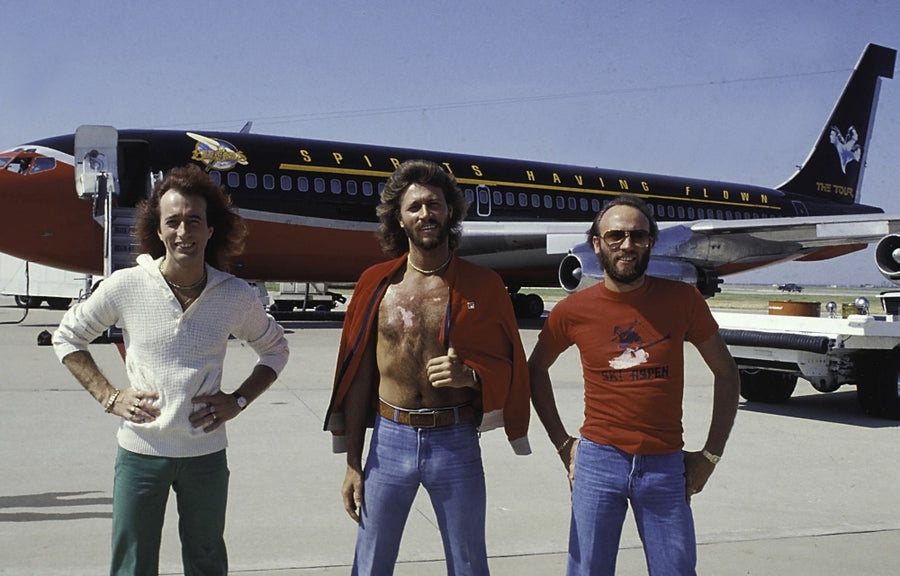 the Bee Gees in front of an airplane Photo Print Image 1