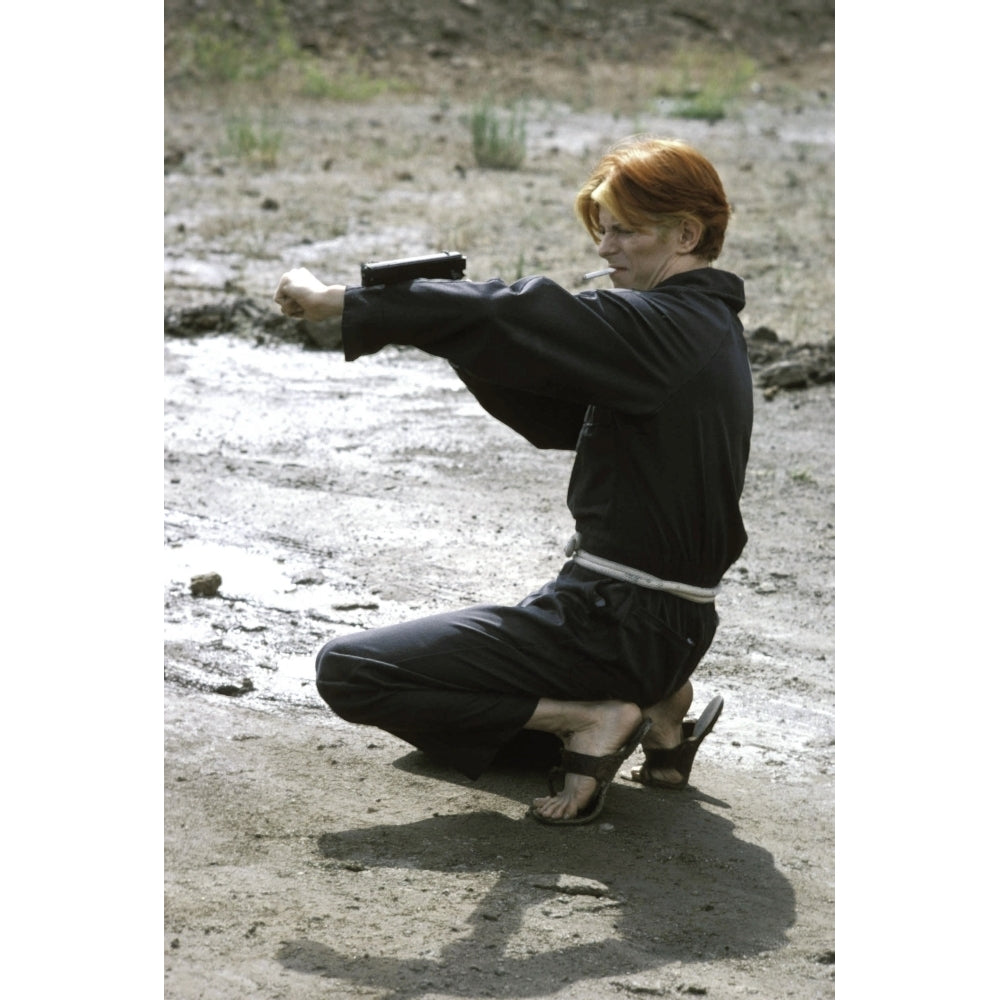 David Bowie aiming a gun Photo Print Image 1