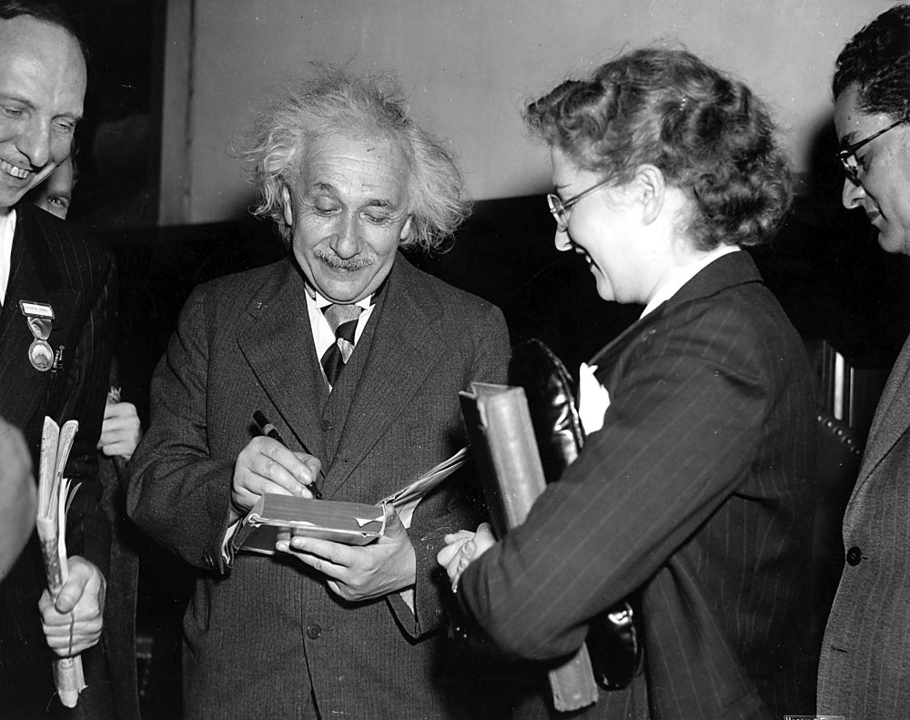 Albert Einstein signing an autograph Photo Print Image 1