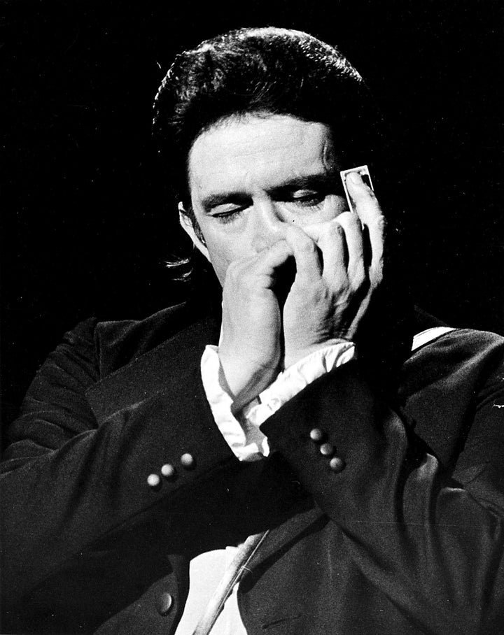 Johnny Cash playing a harmonica Photo Print Image 1