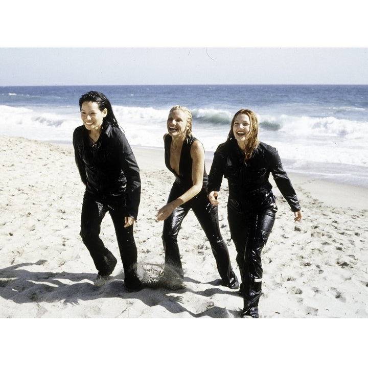 Film still of Lucy Liu Cameron Diaz Drew Barrymore on a beach in Charlies Angels Photo Print Image 1