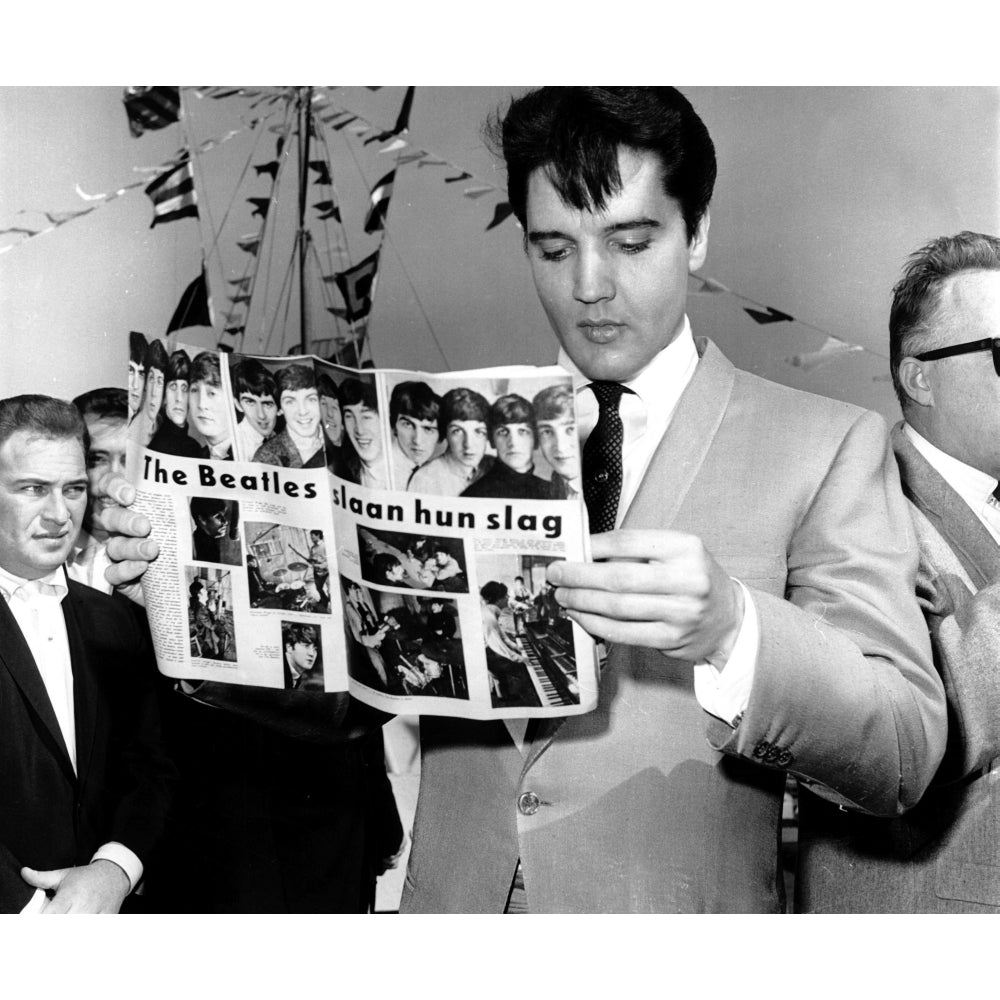 Elvis Presley holding a magazine featuring The Beatles Photo Print Image 1