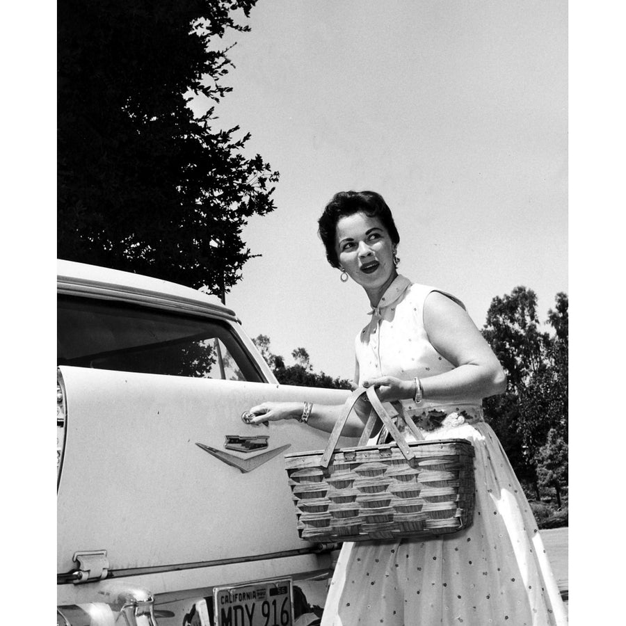 Shirley Temple holding a picnic basket Photo Print Image 1