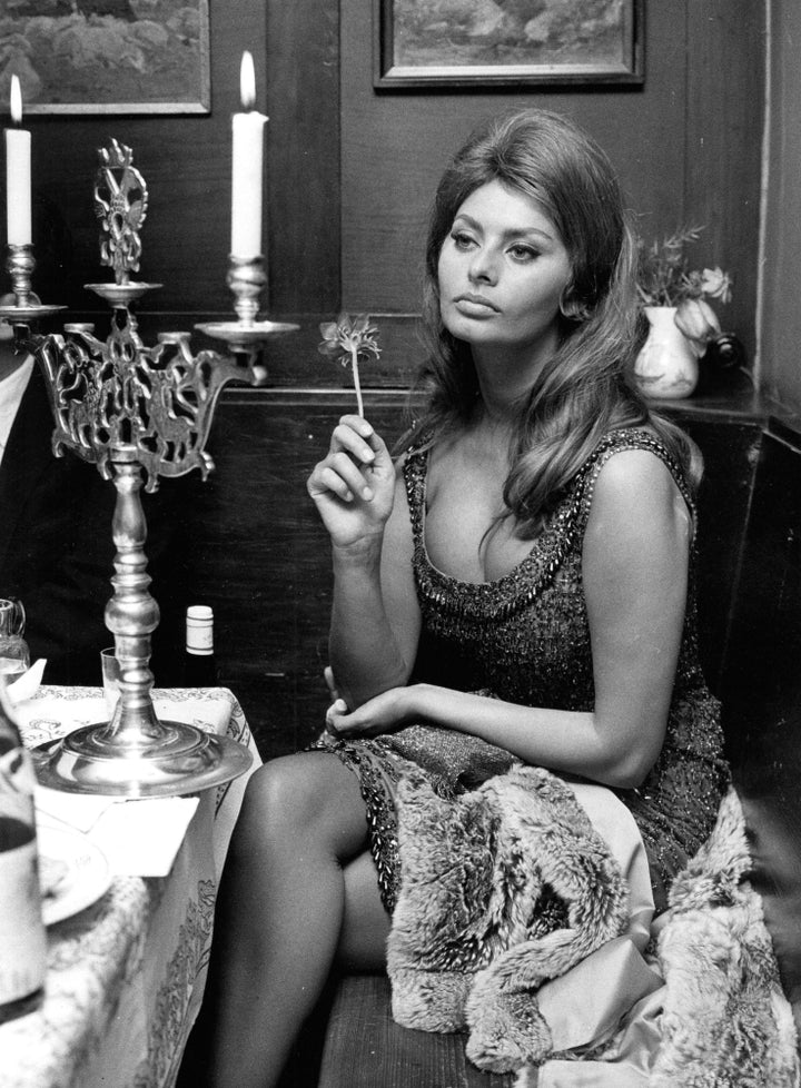 Sophia Loren sitting at a table Photo Print Image 1