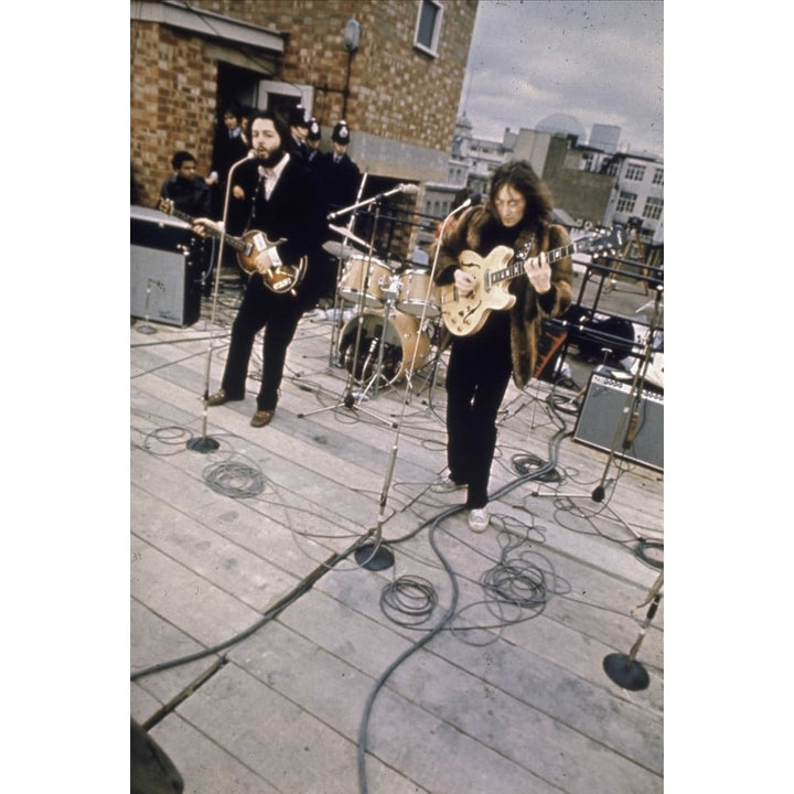 The Beatles performing on a rooftop Photo Print Image 1