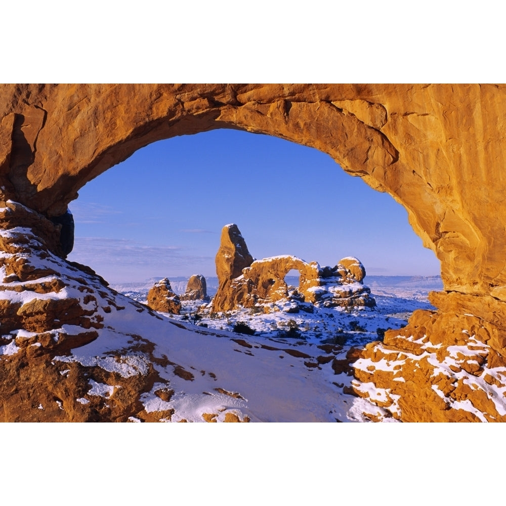 Morning light on North Window framing Turret Arch in winter Arches National Park Utah USA. Poster Print by Russ Bishop Image 1